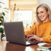 Moderne Maklerin vor Laptop in Büro